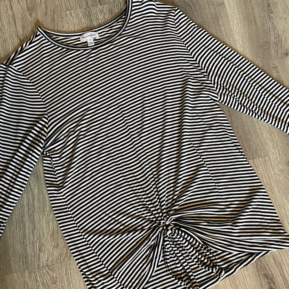 Long sleeve.  Black/white stripes.  Circle tie detail on bottom.